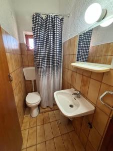 a small bathroom with a toilet and a sink at Pasiphae - Rooms for rent in Agia Galini +49 photos
