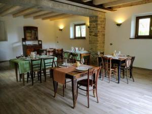 a dining room with wooden tables and chairs at Agriturismo Coradosso "La casetta" in Selvapiana
