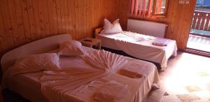 a room with two beds in a room at Casa Rustica in Mamaia Sat/Năvodari