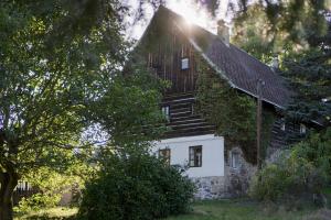 a white house with stairs on the side of it at Roubenka Bohéma in Verneřice