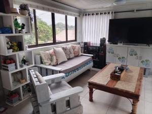 a living room with a couch and a coffee table at Anchors Aweigh in Hibberdene