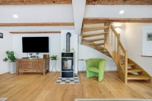 a living room with a staircase and a television at Ferienwohnung Trendelmühle Lautrach in Lautrach