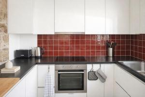 a kitchen with white cabinets and a sink at Casa da Moiroa in Sendim +35 photos