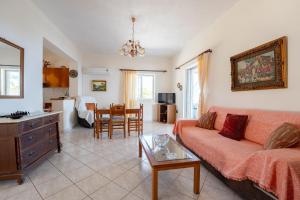 a living room with a couch and a table at Zante's Northern View in Koríthion +18 photos