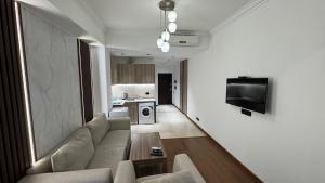 a living room with a couch and a tv on a wall at M&N apartments in Yerevan