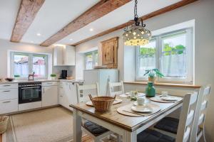 a kitchen with a wooden table and a dining room at Ferienwohnung Trendelmühle Lautrach in Lautrach