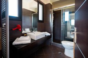 a bathroom with a sink and a toilet at Gaia Villa in Thesprotikón +55 photos