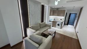 a living room with two couches and a kitchen at M&N apartments in Yerevan