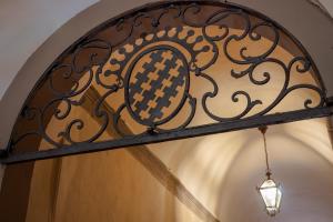 a wrought iron light hanging over a door at Foresteria Valdese di Firenze in Florence