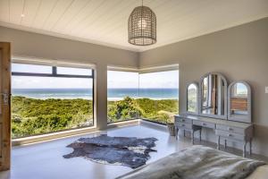 a bedroom with a view of the ocean at Begha 180 Beach House in Begha Mouth