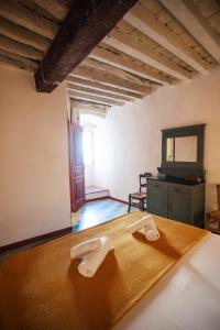a bedroom with a bed with two towels on it at Vivez Bonifacio - Sous le charme in Bonifacio