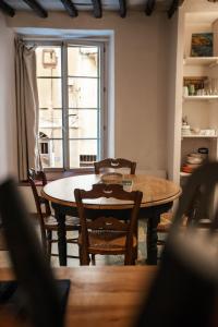 a dining room with a table and chairs and a window at Vivez Bonifacio - Sous le charme in Bonifacio
