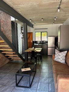 a living room with a couch and a table at Red Robin Guesthouse in Postmasburg