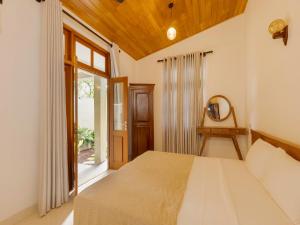 a bedroom with a large bed and a window at The Calm boutique Villa in Ahangama +68 photos