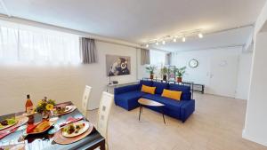 a living room with a blue couch and a table at Fewo Loft Konstanz in Konstanz +17 photos