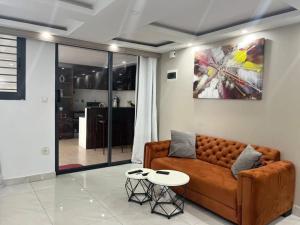 a living room with a couch and a table at Immeuble cgk in Cocody +1 photo