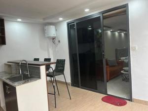a kitchen with a sink and a counter in a room at Immeuble cgk in Cocody