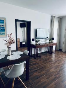 a living room with a dining room table and chairs at Apartament Atrium Sarbinowo in Sarbinowo