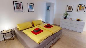 a bedroom with a bed with yellow and red sheets at Fewo Loft Konstanz in Konstanz