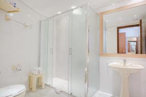 a bathroom with a shower and a toilet and a sink at Nyala Suite Hotel in Sanremo +23 photos