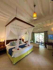 a bedroom with a large bed with a canopy at Sultan Sands Island Resort & Spa in Kiwengwa +73 photos