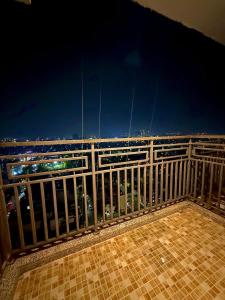 a balcony with a view of the city at night at ITC Grand Stay in Greater Noida