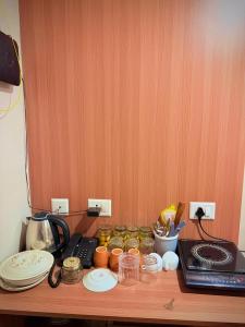 a wooden counter top with jars of food on it at ITC Grand Stay in Greater Noida