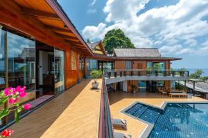 an external view of a house with a swimming pool at Luxury 4 pool Seaview 6 bedroom Villa on Surin Hill in Surin Beach