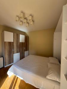 a bedroom with a large bed and a ceiling at Spiranca Cityview Residence in Tirana
