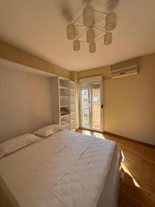 a bedroom with a bed and a ceiling fan at Spiranca Cityview Residence in Tirana