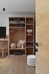 a room with a shelf with baskets and a table at Residence Stella Alpina in Santa Cristina Gherdëina +28 photos