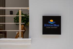 a sign on a wall with a hat on it at Kitron Blue Seaside Luxury Apartment in Agios Nikolaos