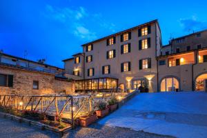a building with a courtyard in front of it at Palazzo Saloni in Montalcino