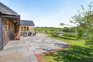 a patio with tables and chairs and a house at 3 Bed in Bassaleg oc-bow138 in Bassaleg