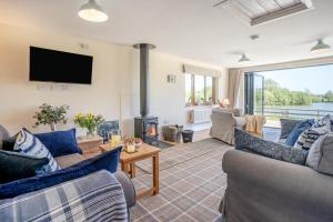 a living room with couches and a fire place at 3 Bed in Bassaleg oc-bow138 in Bassaleg