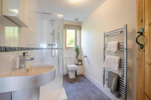 a white bathroom with a sink and a toilet at 3 Bed in Bassaleg oc-bow138 in Bassaleg +22 photos
