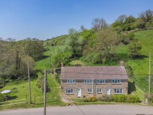 an old brick house on a grassy hill at 2 Bed in Bridport oc-58848 in Powerstock