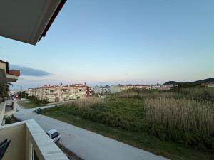 a view from a balcony of a street and buildings at Apartment Deniz in Nea Peramos