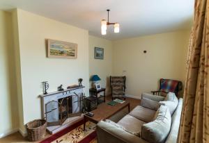 a living room with a couch and a fireplace at Sneem Townhouse in Sneem