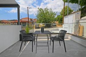 a black table and chairs on a patio at Agios Nikolaos Villas in Agios Nikolaos