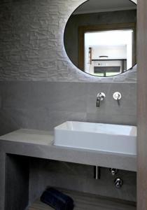 a bathroom with a white sink and a mirror at Agios Nikolaos Villas in Agios Nikolaos