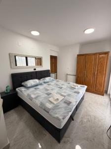 a bedroom with a large bed in a room at Rooms Vesna in Salopek-Selo
