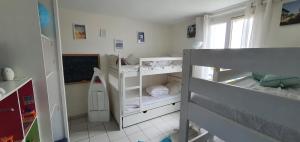 a small room with two bunk beds and a chalkboard at Villa Belle Ile in Saint-Pierre-dʼOléron +8 photos