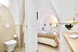 a bathroom with a bed and a toilet in a room at Il Rifugio Dei Nonni in Ostuni +16 photos