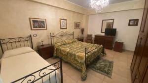 a bedroom with two beds and a television in it at Sole nascente in Furci Siculo +53 photos