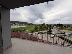 a balcony with a fence and a view of a street at Rooms Vesna in Salopek-Selo