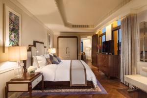 a bedroom with a large bed and a television at Jinjiang Metropolo Hotel Classiq,Shanghai Bund Circle in Shanghai