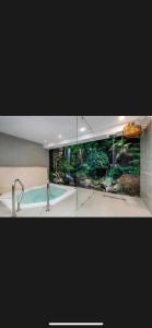 a bathroom with a sink and a swimming pool at Apartament Atrium Sarbinowo in Sarbinowo