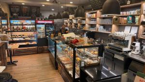a bakery with a person standing in a store at Castello Rosso Apartman in Pilisvörösvár