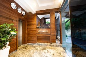 a lobby with wood paneling and a sign on the door at Garden Ridge in Abuja